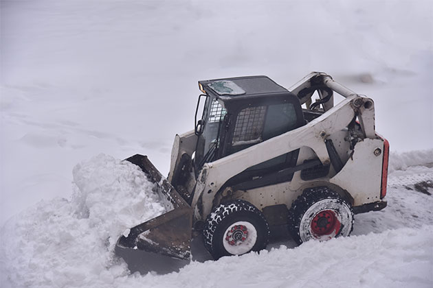 Skidsteer Plowing Snow Near McGregor, MN